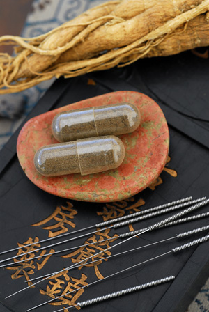 A photo of Chinese Medicine herbal caplets and acupuncture needles.